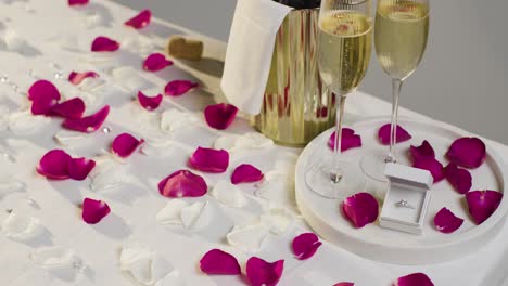 Table-Set-For-Romantic-Marriage-Proposal-With-Champagne-And-Engagement-Ring-2
